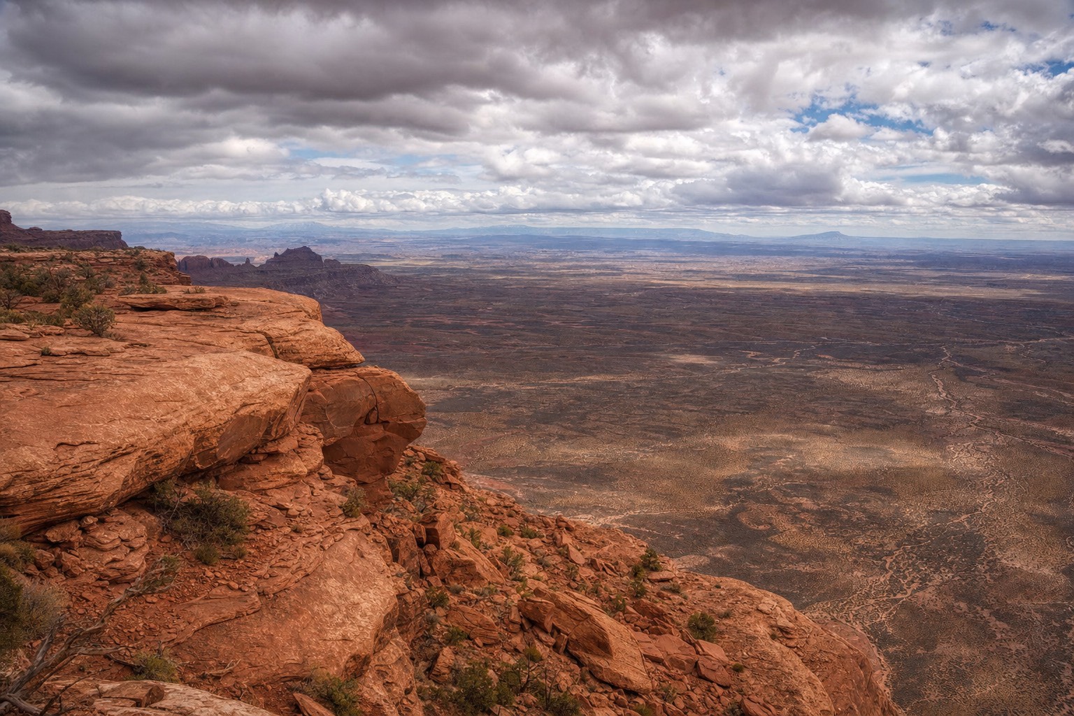 A sweeping panoramic view of Red Rock Canyon's red sandstone escarpment