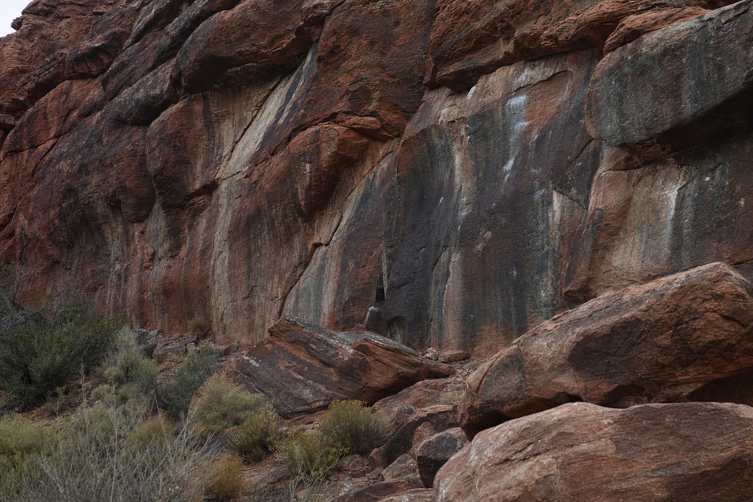 Sandstone boulders with visible climbing chalk at a Red Rock Canyon bouldering area